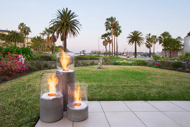 Naked Flame Biofuel Fireplaces NZ - Ecosmart - 3 Tall Round Fires On Patio